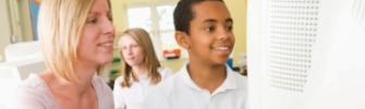 Education - teacher and pupil at a computer