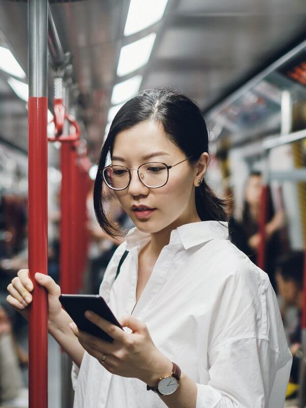 Woman looking at her phone on public transport