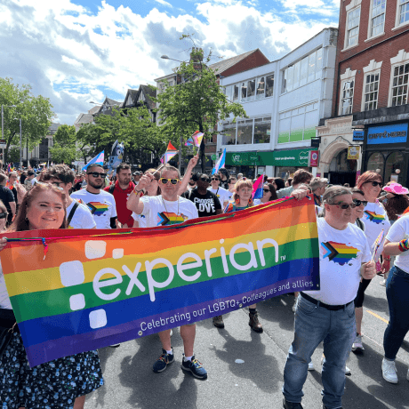 6 of 13 logos - People at Pride with rainbow flags and t shirts 