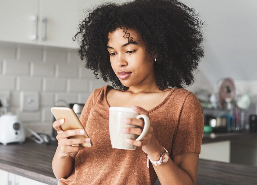 Young woman using her phone to shop online