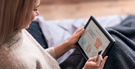 A woman online shopping on her tablet.