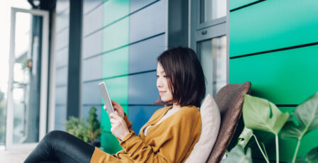 woman outside house on their phone