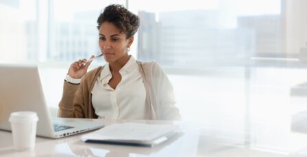 Woman at desk making decisions