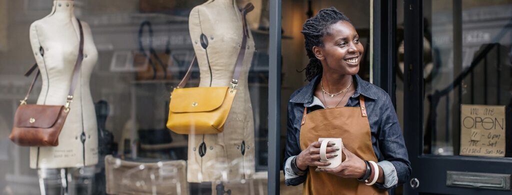 Small business owner taking a break outside her shop