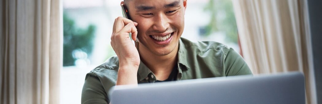 young man talking happily on phone