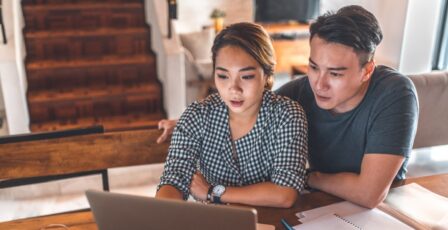 Couple browsing on a laptop