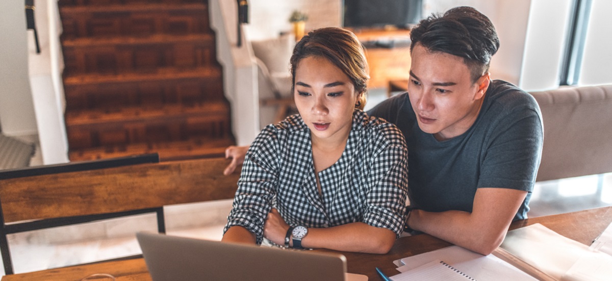 Couple browsing on a laptop