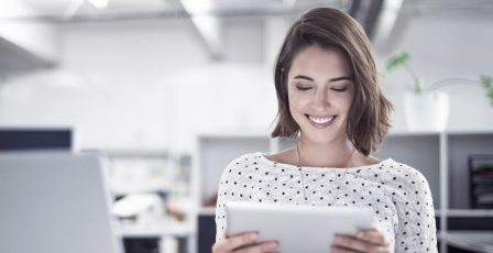 Woman smiling while on iPad