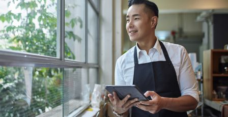 Barista with digital tablet at cafe