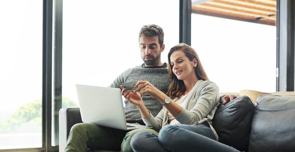 couple with credit card and laptop