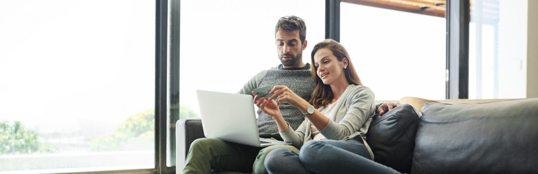 couple with credit card and laptop