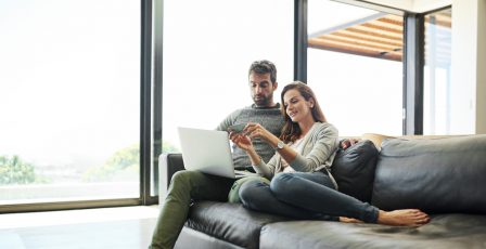 couple with credit card and laptop