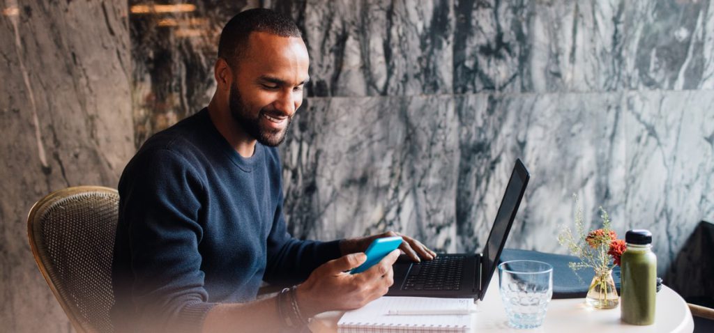 Man using mobile phone while in a cafe