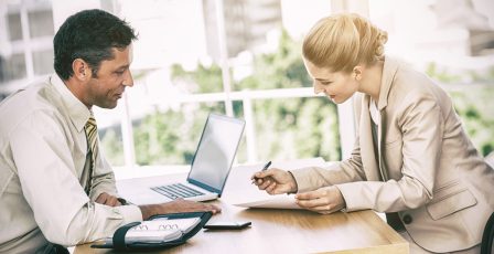 Businesswoman signing contract at interview