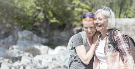 Senior woman and daughter hiking in mountains