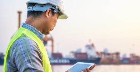 Maintenance engineer monitoring data on a tablet