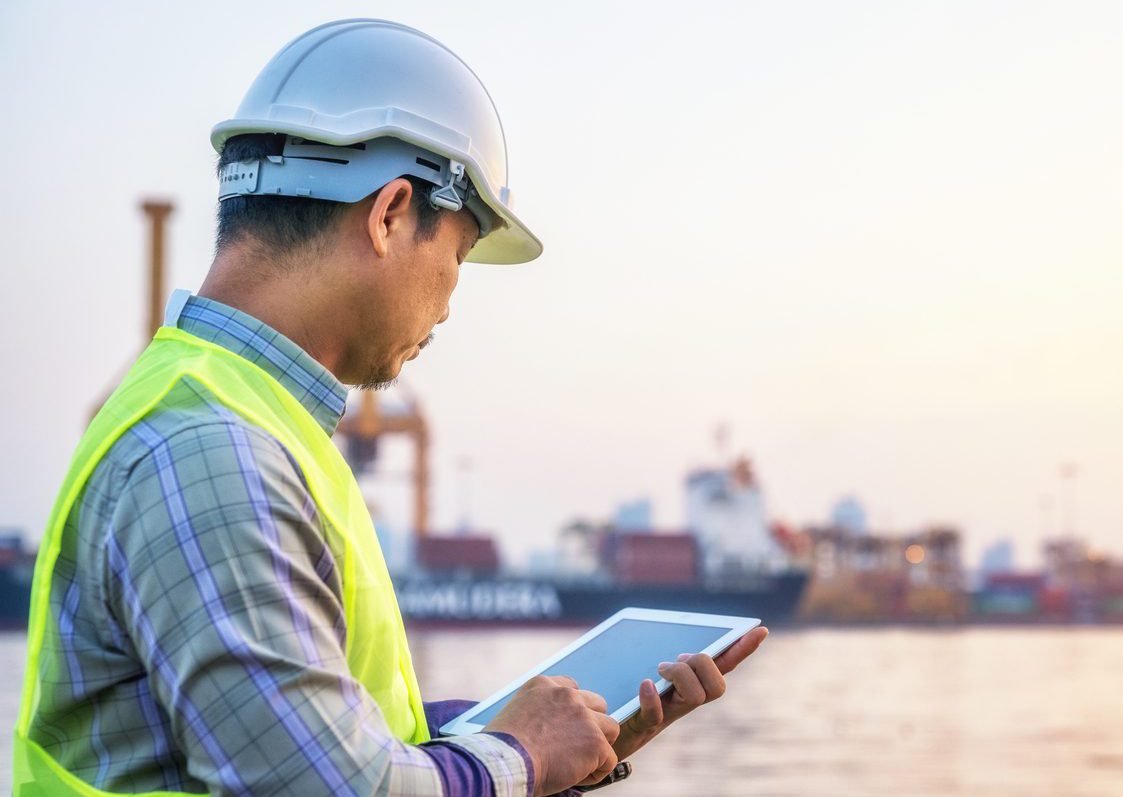 Maintenance engineer monitoring data on a tablet