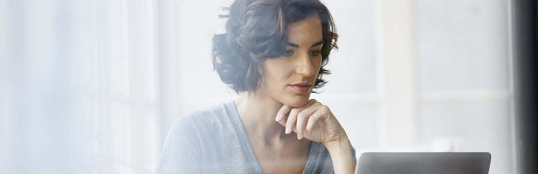 Businesswoman using laptop in office