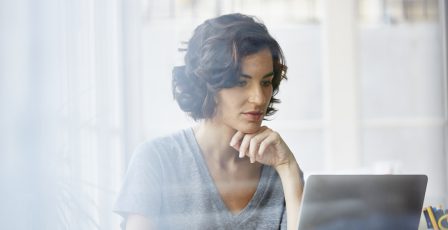 Businesswoman using laptop in office