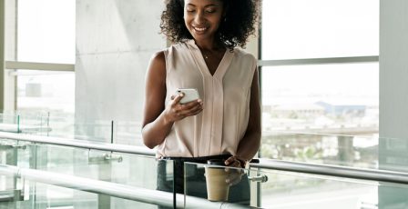 Young woman at work using her mobile phone