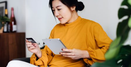 Young woman using her credit card online