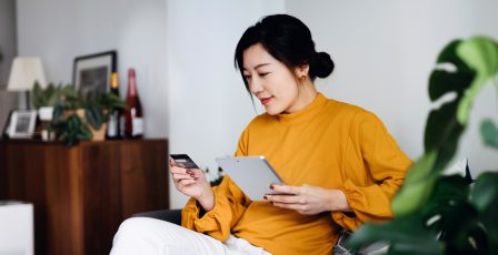 Young woman using her credit card online