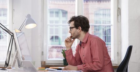 Man sitting at a desk while working from home