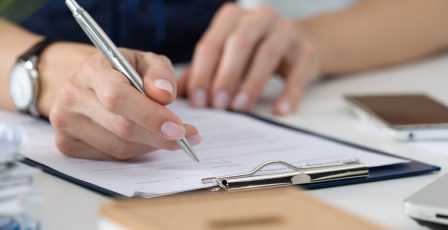 Businesswoman filling out paperwork