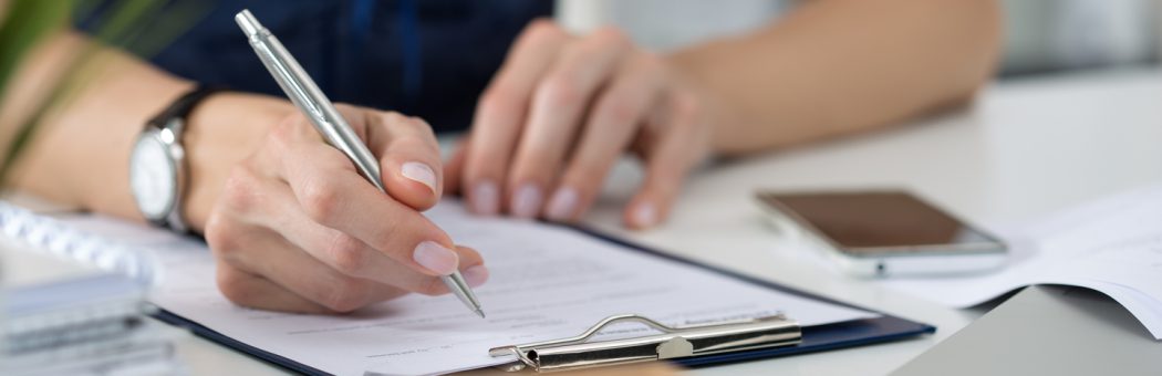 Businesswoman filling out paperwork