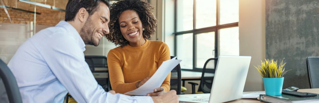 Two colleagues looking at a marketing plan