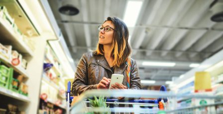 Woman shopping in supermarket during cost of living crisis