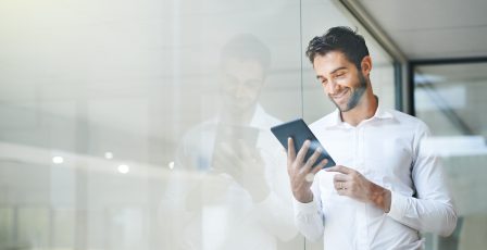 Man on a tablet stood by a window