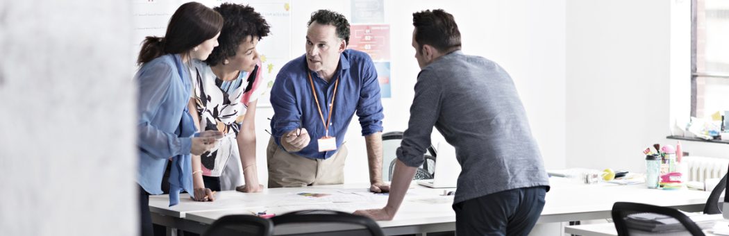 Colleagues brainstorming in tech start-up office