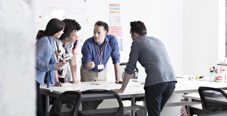 Colleagues brainstorming in tech start-up office