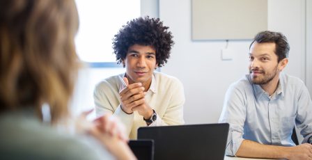 A financial services team talking in a meeting room