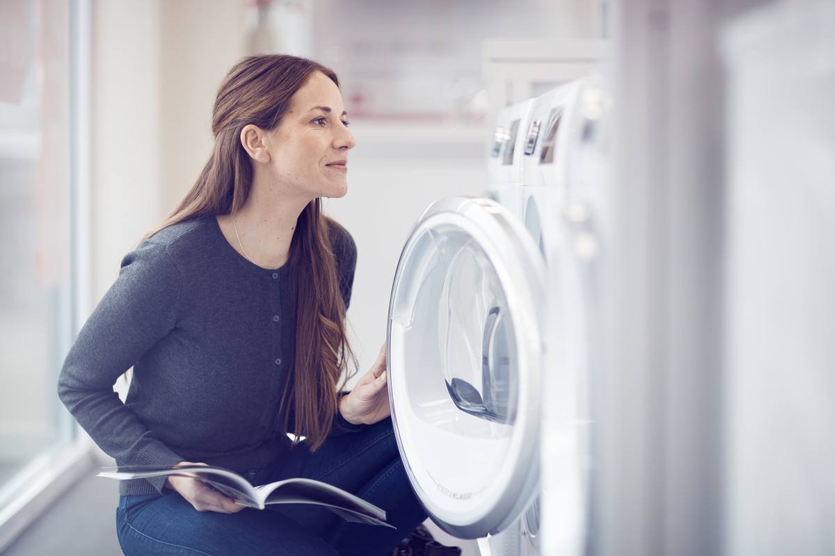 Customer inspecting washing machine