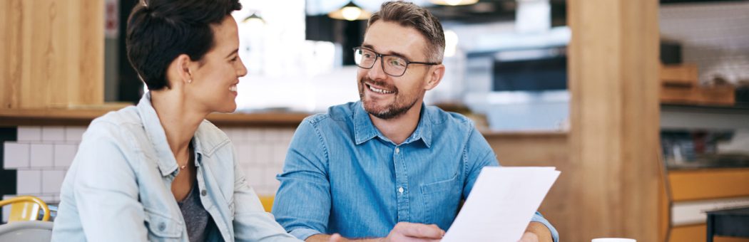 Two people looking over a contract