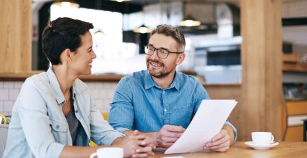 Two people looking over a contract