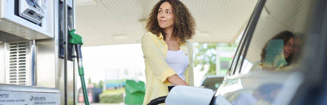 Woman filling her car up from a petrol pump