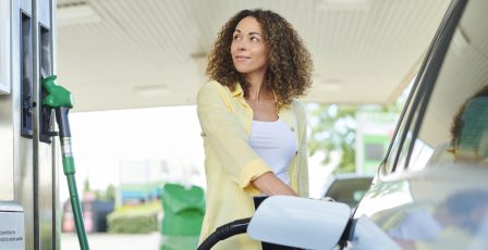 Woman filling her car up from a petrol pump