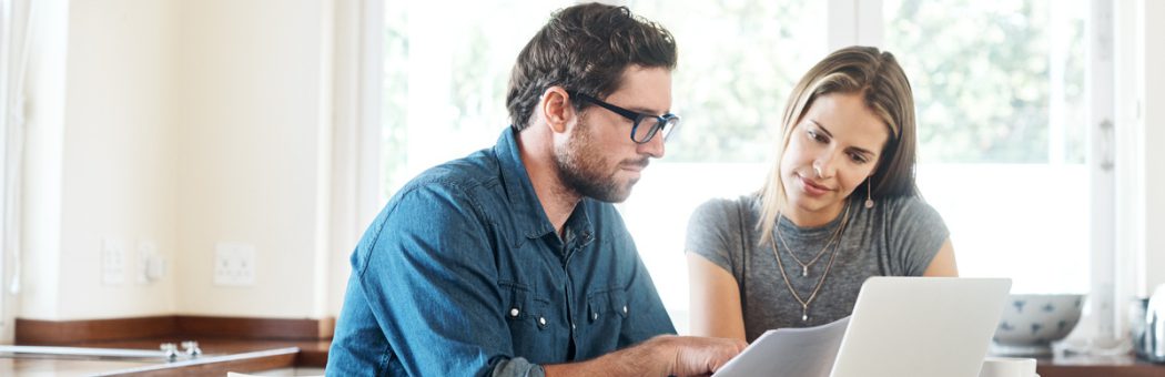 Young couple working on their finances together at home