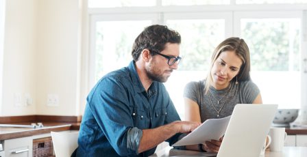 Young couple working on their finances together at home