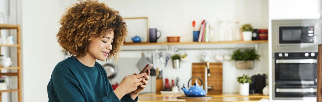 Young woman shopping online with her mobile phone