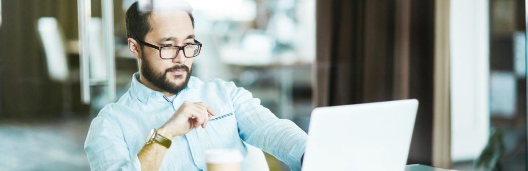 Businessman looking at laptop display at workplace