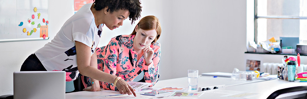 Two young professionals discussing a data project