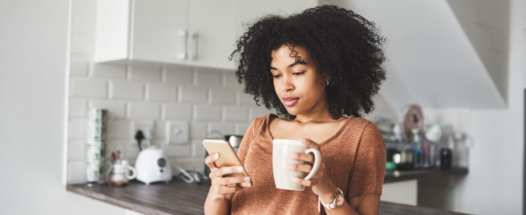 Young woman using her phone to shop online