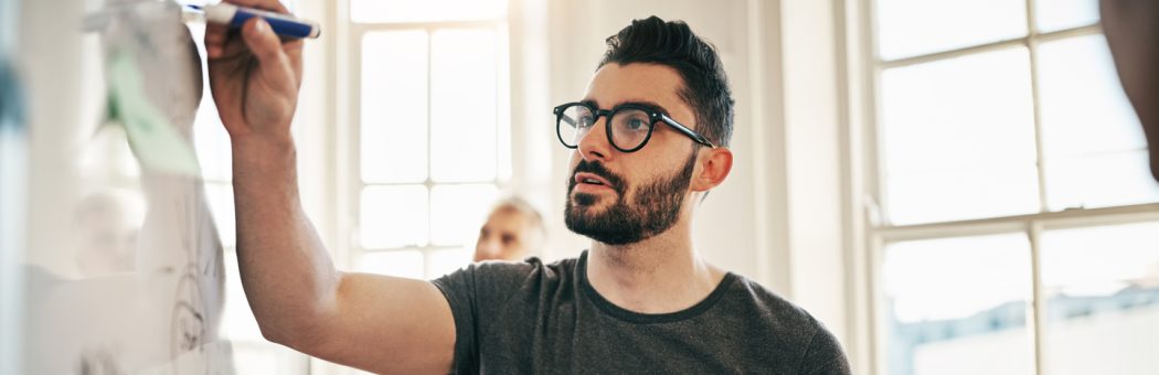 A young professional taking notes in a data workshop