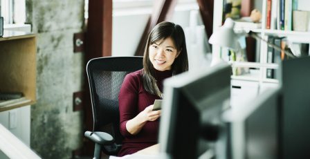 Employee sat smiling in an office