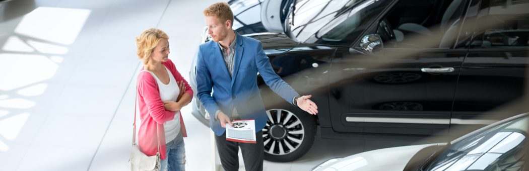 Woman being shown a car in a showroom