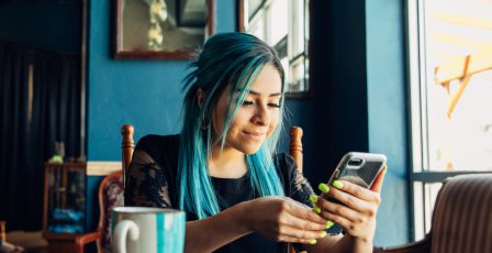 Young woman using her mobile phone in a restaurant